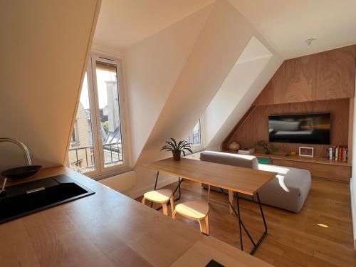 un salon avec une table et un canapé dans l'établissement Au coeur de Montmartre, à Paris