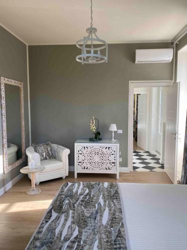 a living room with a couch and a chandelier at Villa Chloé in Montecalvo Versiggia