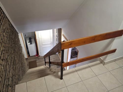 a staircase with a wooden railing in a house at Panoramic house in Szigliget in Szigliget