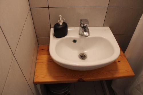 a white sink sitting on a wooden counter in a bathroom at LaCasa Garden in Skiathos Town
