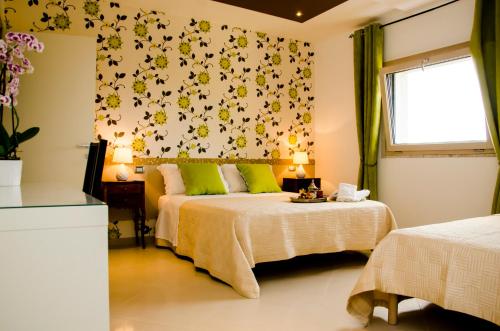 a bedroom with two beds and a window at Villa Le Favole in Sant'Egidio del Monte Albino