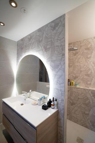 a bathroom with a sink and a mirror at CooLiving de la fôret in Béthemont-la-Forêt