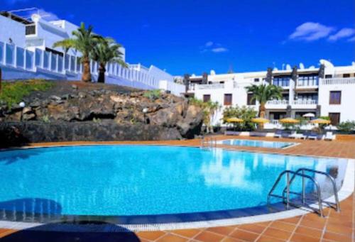 a large swimming pool in front of a building at B16 caleton blanco in Puerto del Carmen
