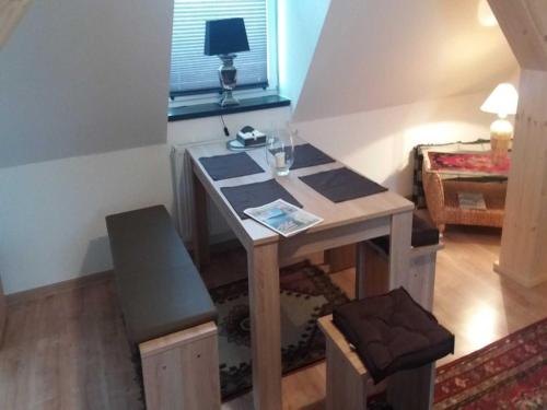 a wooden desk in a room with a window at Gästehaus Alte Schule in Buschhof