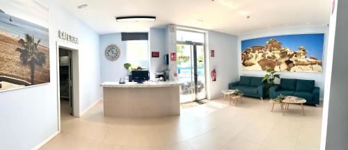 a lobby with a waiting room with blue furniture at Apartahotel Puerto Blue in Puerto de Mazarrón
