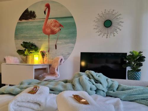 a bedroom with a bed with a towel on it at FlamingoSuite 6 min zum See in Herrsching am Ammersee