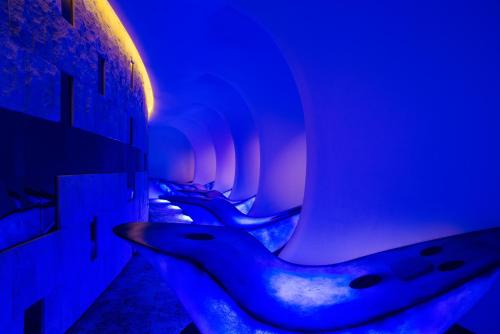 a row of toilets in a room with blue lights at Sofitel Kunming in Kunming