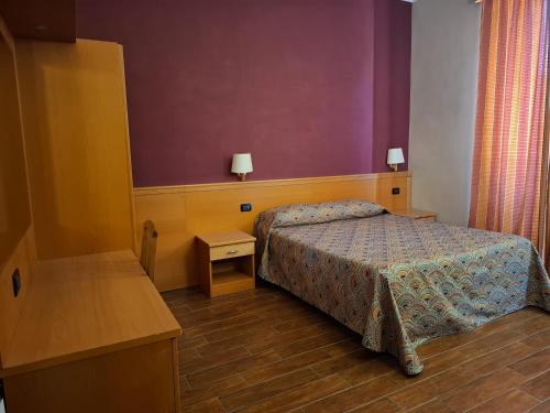 a hotel room with a bed and a desk and a bed sidx sidx sidx at Beauty Rooms in Rome