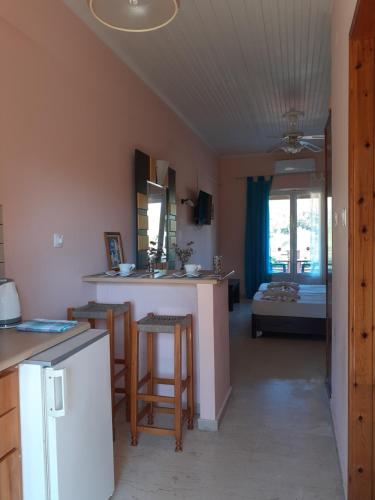 a room with a kitchen and a living room at ILENIMA Hotels in Agios Stefanos