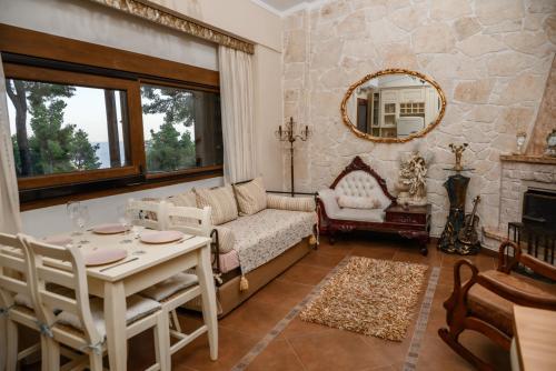 a living room with a couch and a table at Sani Villa Elmira in Sani Beach