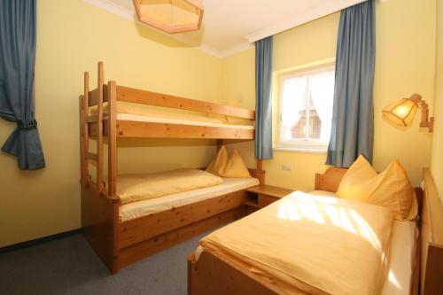 a bedroom with two bunk beds and a window at Gästehaus Katharina in Schladming
