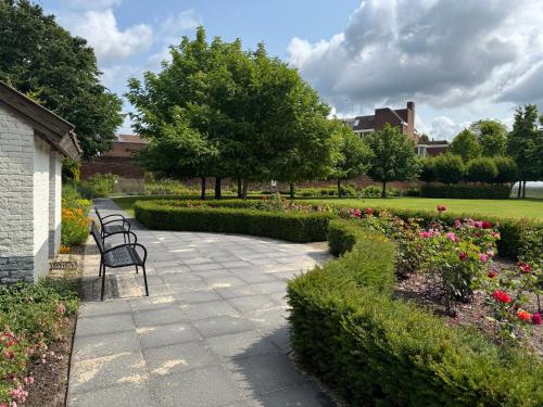 a row of benches in a park with flowers at B&B Maria Hart in Weert