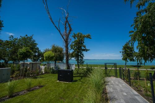 a park with a tree and a swing at MyFlat Wave Botanic Apartment in Siófok
