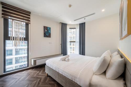 a bedroom with a large bed and large windows at Studio-GH5 - Vinhomes Grand Park - Thu Duc City in Long Bình