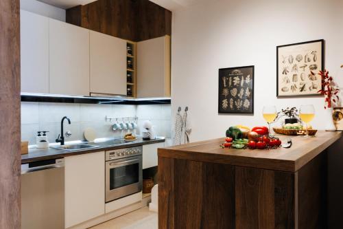 a kitchen with a counter with fruits and vegetables on it at Harmonic Nest 3min to Republic Square Renovated in Belgrade
