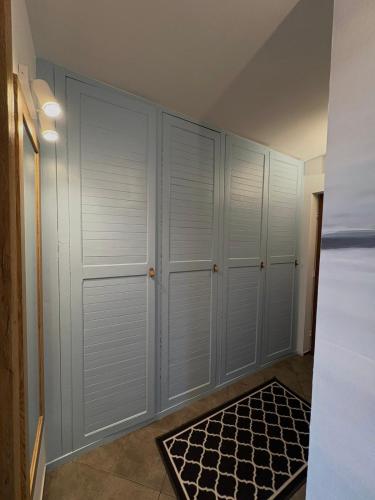 a room with white closets and a rug at Apartament Słowackiego Sopot in Sopot