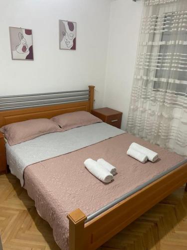 a bedroom with a bed with two towels on it at Centar Apartment in Kumanovo