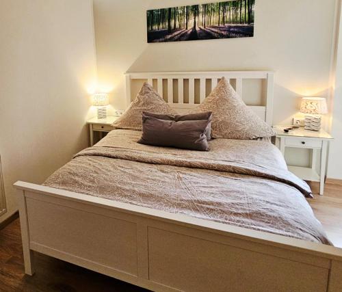 a bed with two pillows on it in a bedroom at Ferienwohnung Inselblüte in Werder