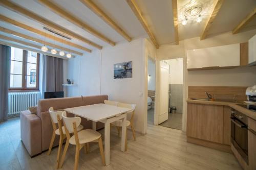 une cuisine et un salon avec une table et des chaises dans l'établissement Le Parmelan - apartment for 2 people in the heart of the old town, à Annecy