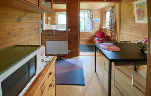 a small kitchen with a table and a stove at 1 Bedroom Nice Home In Byxelkrok in Byxelkrok
