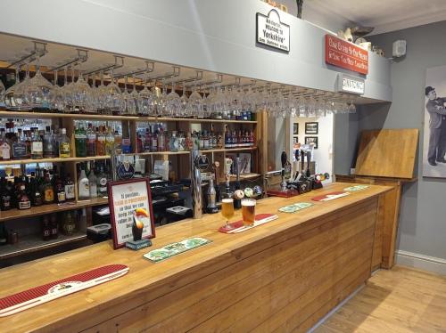 a bar with glasses on top of it at Salmon Leap Hotel in Whitby