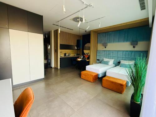 a large room with two beds and a kitchen at Jasna SportHotel & SPA in Gliwice