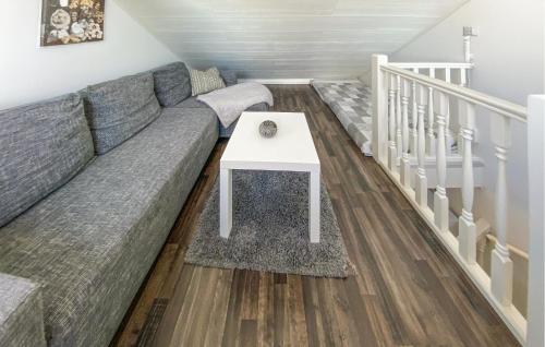 a living room with a couch and a table at 2 Bedroom Lovely Home In Köpingsvik in Köpingsvik