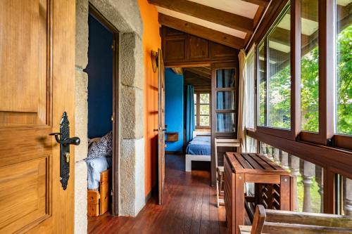 a hallway of a house with a wooden door at La Quintana de la Foncalada in El Cabritón