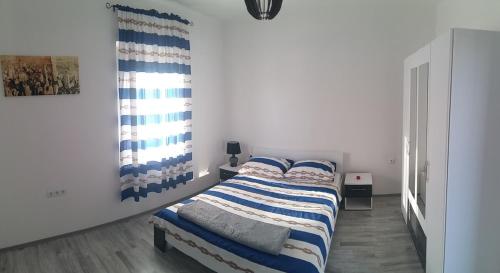 a bedroom with a bed and a painting on the wall at Apartment Zaglav in Zaglav