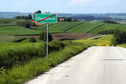 a sign on the side of a road in a field at Dosłońce Resort Wellness & Farm in Racławice