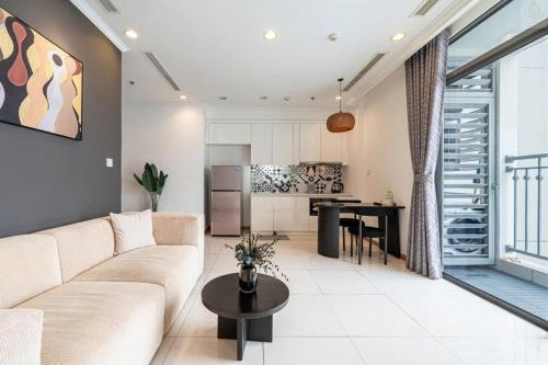 a living room with a couch and a table at Landmark Plus Vinhomes CityView Suite in Ho Chi Minh City