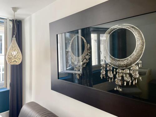 - un salon avec deux miroirs sur un mur dans l'établissement 202419 - Elegant apartment for 6 people in the Montorgueil area, à Paris