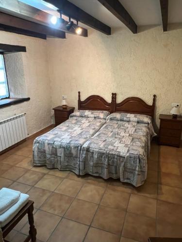 a bedroom with a large bed in a room at La Cerezal II in Borines