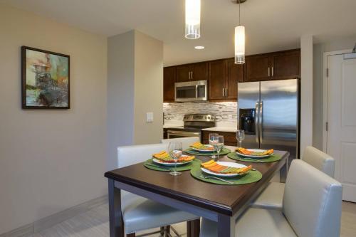 a kitchen and dining room with a table and chairs at Residence Inn by Marriott Daytona Beach Oceanfront in Daytona Beach