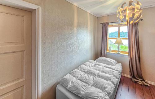 a small bedroom with a bed and a window at Nice Home In Manger With House Sea View in Manger