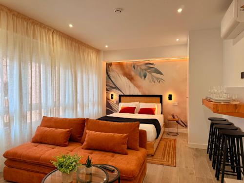 a living room with a bed and a couch at dozZze - Madrid Río in Madrid