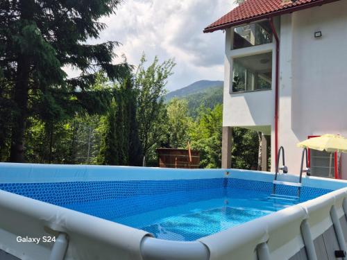 a pool on the balcony of a house at Vila Roberta Breaza ,BV in Breaza