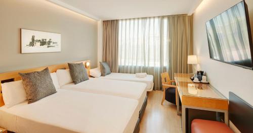 Ένα ή περισσότερα κρεβάτια σε δωμάτιο στο Sercotel Caspe