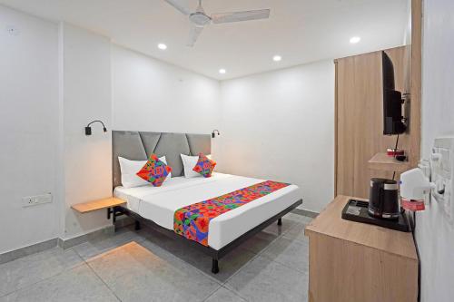 a bedroom with a bed and a television in it at FabHotel Grand Olive I in Noida