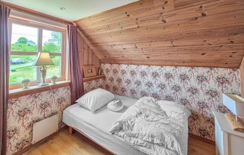 a bedroom with a bed in a room with a window at Nice Home In Manger With House Sea View in Manger