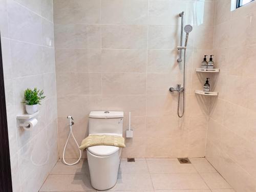 a bathroom with a toilet and a shower at MokuMoku Miri Homestay FOC Netflix & Ytb 18pax in Miri
