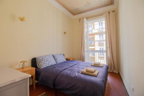 une chambre avec un lit avec deux serviettes dessus dans l'établissement Le charme de l'ancien, rénové - Nice - 4 personnes, à Nice