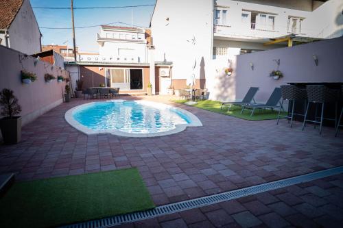 a swimming pool in the middle of a patio at Penthouse Secret Rose with pool, jacuzzi, sauna, private garage, entry with pin 0-24h in Slavonski Brod