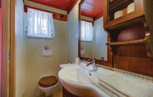 a bathroom with a sink and a toilet and a mirror at House Victoria 1 by Villas Guide in Nerezine