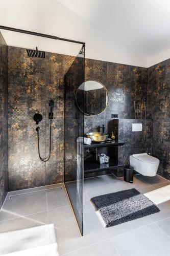 a bathroom with a shower with a toilet and a sink at Villa Vilma-house with heated pool & garden in Trilj