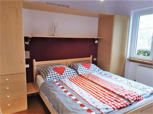 A bed or beds in a room at Belvilla by OYO PAN03 3 - Residenza Panorama