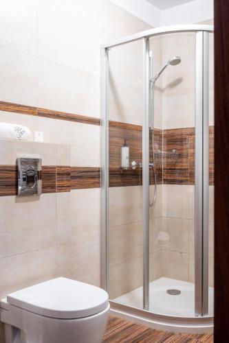a shower stall in a bathroom with a toilet at Hotel Willa Pod Skocznią in Zakopane