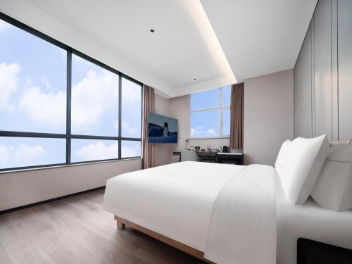Ένα ή περισσότερα κρεβάτια σε δωμάτιο στο Atour Hotel Xian Greater Wild Goose Pagoda