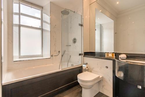 a bathroom with a toilet and a shower and a sink at Norton House Hotel & Spa, Edinburgh in Ingliston