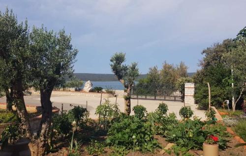 a garden with trees and flowers in a park at House Victoria 2 by Villas Guide in Nerezine
